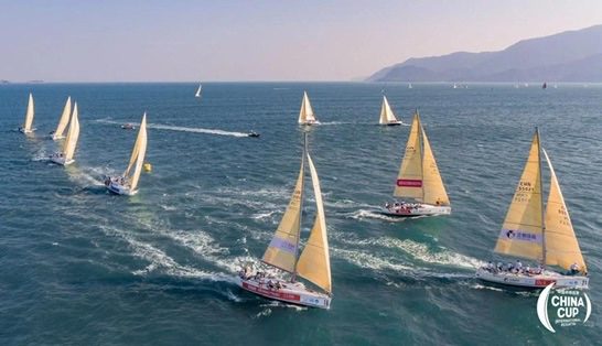 A fleet of race yachts under sail